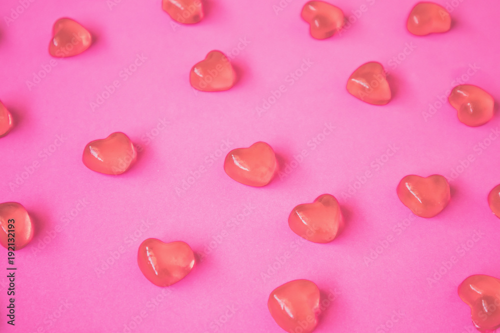 Valentines day background with heart shape candy on pink background