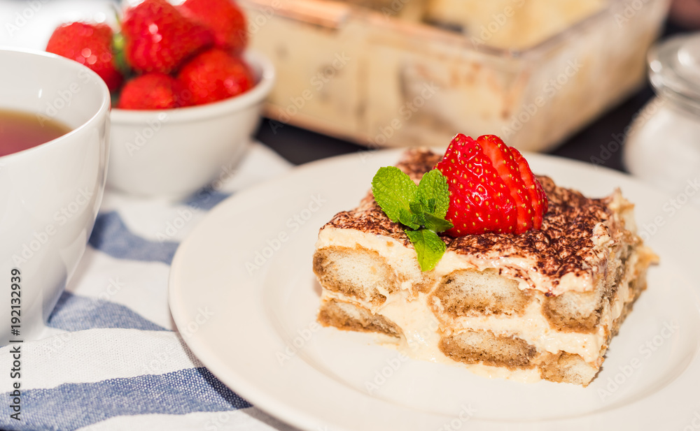 tiramisu cake decorated with strawberries Italian cuisine, Selective focus