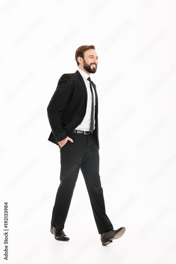 Happy young businessman walking isolated Happy young businessman walking isolated
