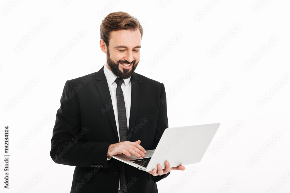 Happy young businessman using laptop computer. Happy young businessman using laptop computer.