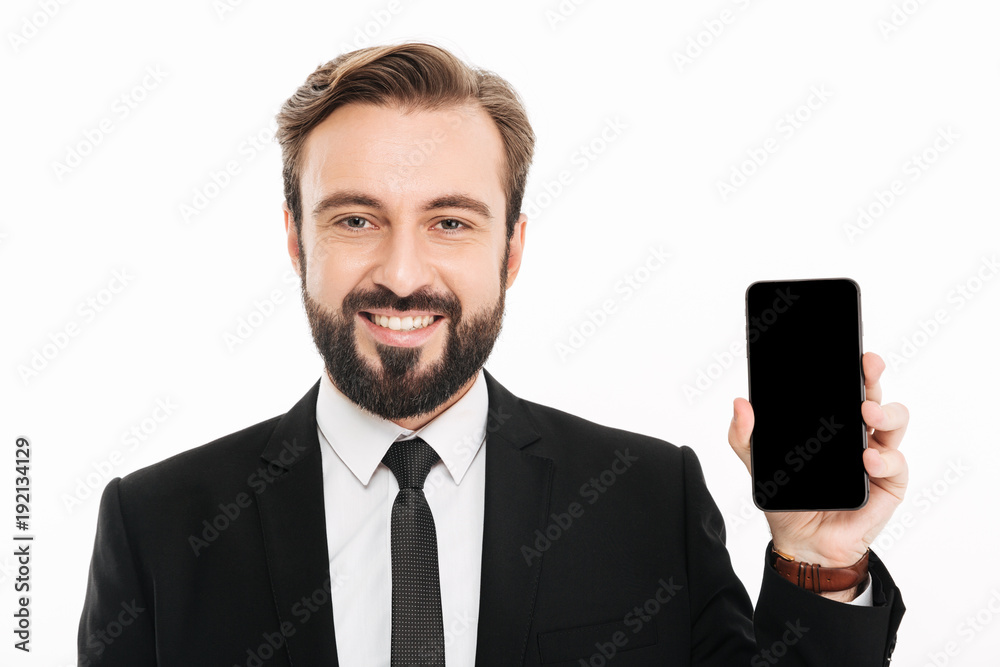Cheerful young businessman showing mobile phone. Cheerful young businessman showing mobile phone.