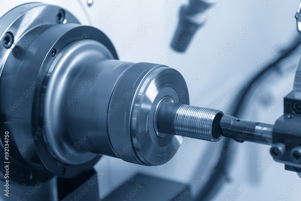 The CNC lathe machine cutting the thread at the end of the pipe.The water pipe manufacturing process. The CNC lathe machine cutting the thread at the end of the pipe.The water pipe manufacturing process.