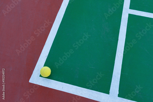 tennis ball just inside of the corner of a hard court © Freer