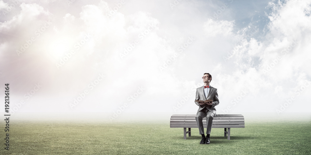 Young businessman or student studying the science in summer park Young businessman or student studying the science in summer park