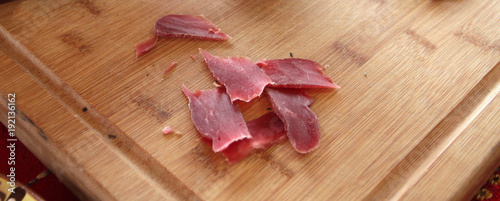 Jerky. Pastrami or pastramy is a highly seasoned smoked beef, typically served in thin slices. Pastterma is a delicacy of beef, sheep, pork and goat meat. Jerked meat, pastirma. photo