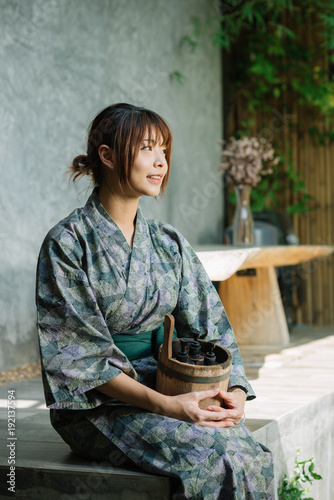 Onsen series: Asian woman holding wooden bucket in onsen