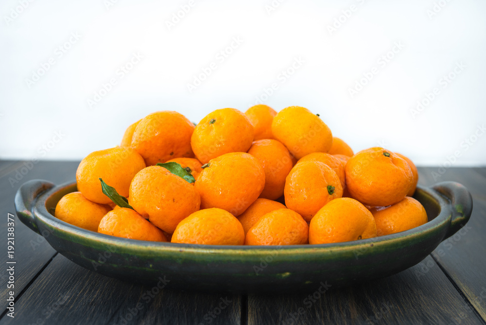 A platter of fresh orange Clementines or Algerian Mandarins