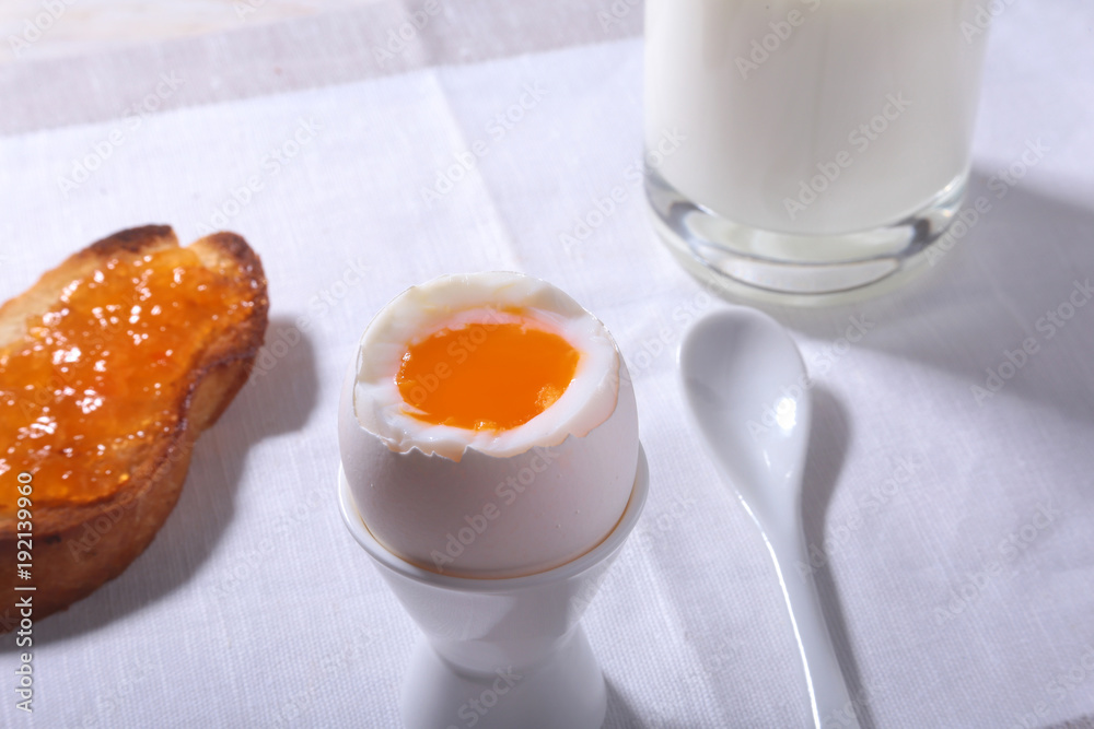 Morning Breakfast set with egg, orange jam on bread toast and milk in glass. Morning Breakfast set with egg, orange jam on bread toast and milk in glass.