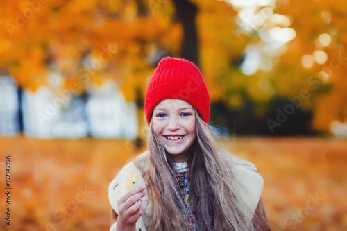 Outdoor portrait of cute little girl on the autumn meadow