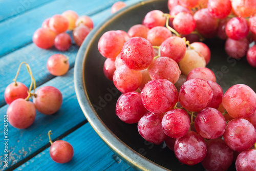 Fotografija A plate of pink wet grapes macro