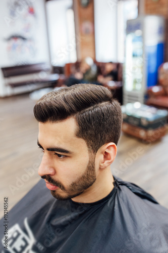 male model shows a haircut in a barber shop