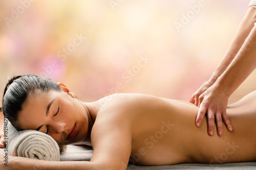 Side view of woman having hot oil massage is spa.
