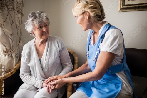 Nurse taking care of a senior woman photo