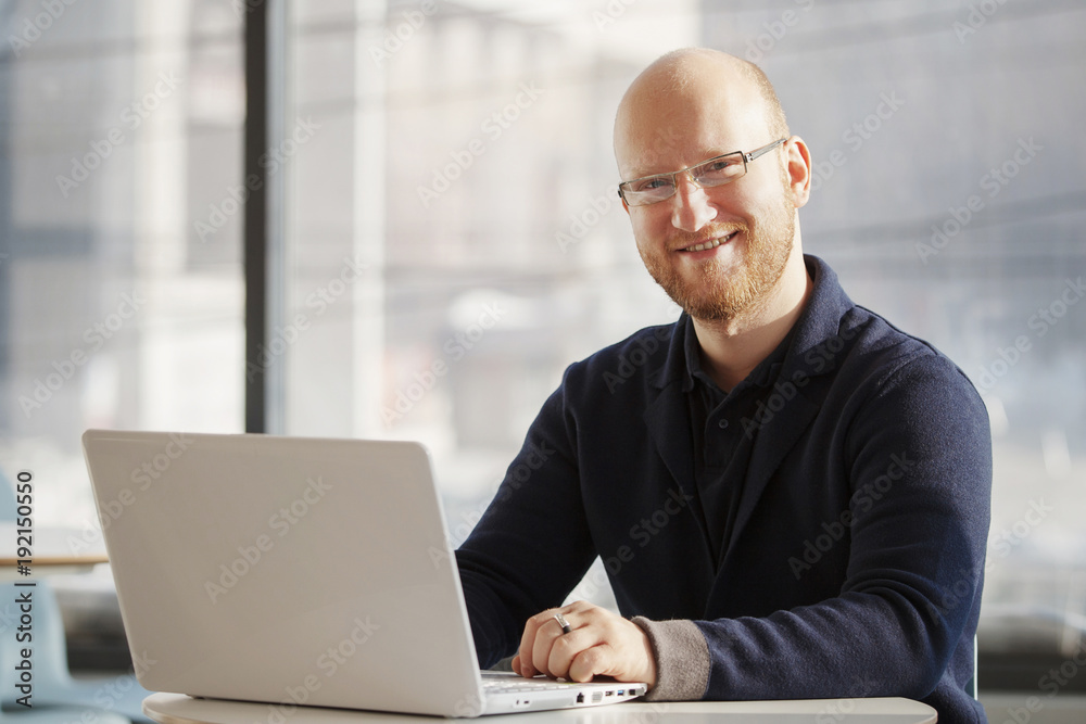 Businessman in the office sitting and working with laptop Businessman in the office sitting and working with laptop