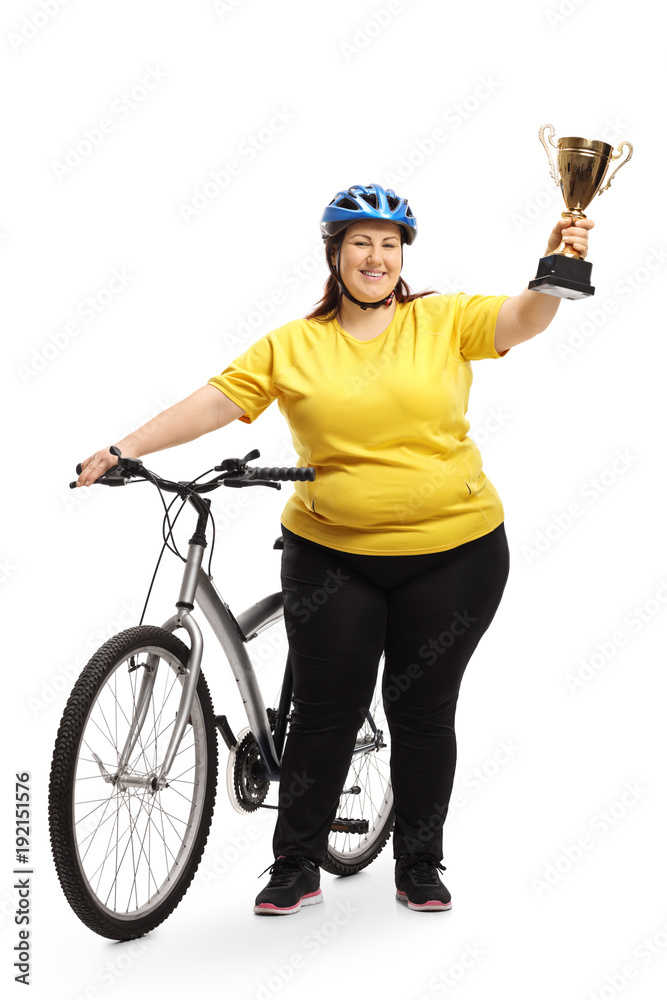 Overweight woman with a bike and a golden trophy Overweight woman with a bike and a golden trophy