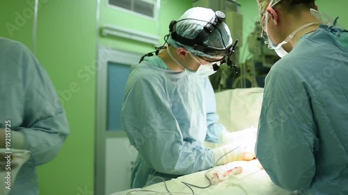 surgeons at work. female nurse operating in child surgery hospital photo
