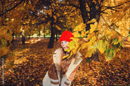 beautiful young happy girl in autumn park