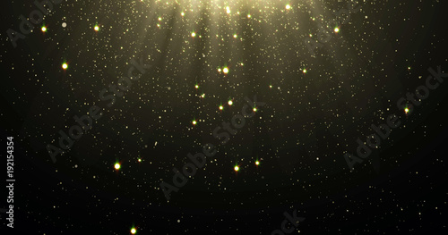 Abstract gold glitter particles background with shining stars falling down and light flare or glare overlay effect above for luxury premium product design template backdrop. Magic light radiance photo