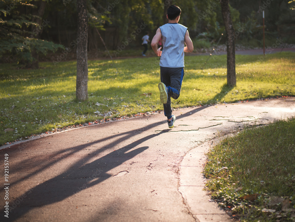 Fototapeta premium Young asian man running in park, Healthy lifestyle concept.