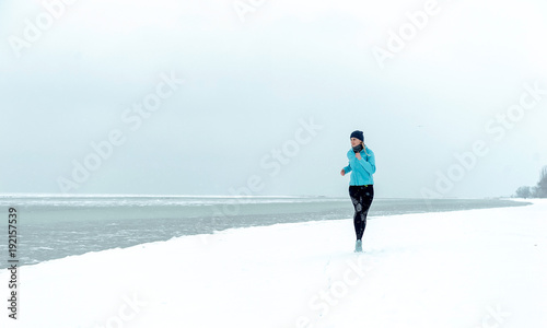 winter running on the snow-covered beach. The concept of a healthy lifestyle and sport regardless of weather and season