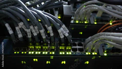 Working Ethernet switch in data center room, connecting computers together. Working Ethernet server. RJ45 jacks blinking LED lights. Close up. 