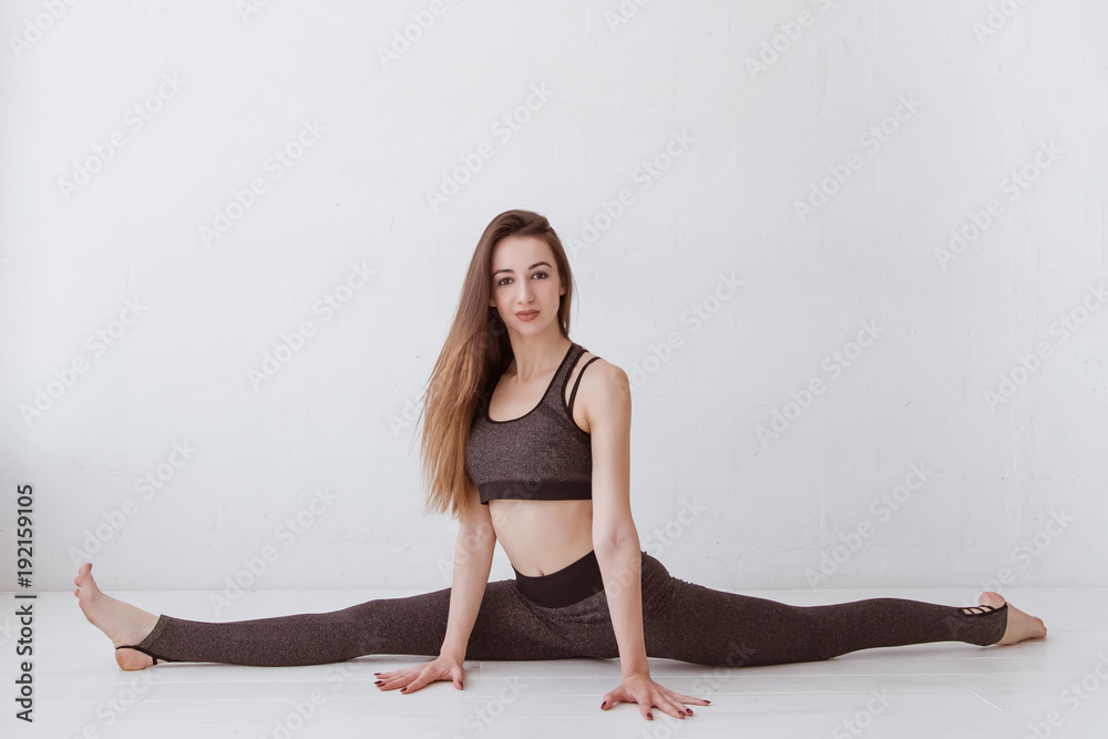 girl on a twine in a white studio. Young female, practicing yoga. Lifestyle. girl on a twine in a white studio. Young female, practicing yoga. Lifestyle.