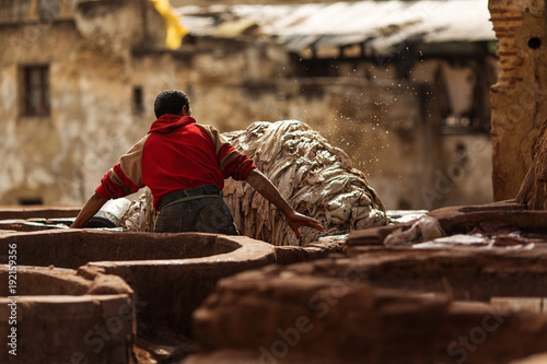 Man working hard on a tennery in Fez town of Morocco