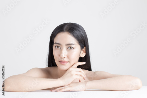 Beautiful Asian Woman Portrait. Beautiful Woman looking to camera. Korean Woman Touching her Face. People with Youth and Skin Care Concept. isolated on white background.