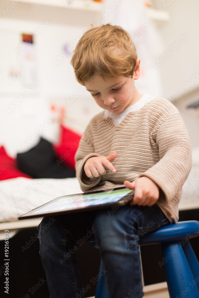 Blonde and cute boy playing with tablet Blonde and cute boy playing with tablet