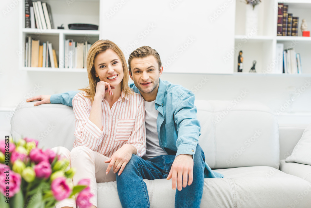 portrait of smiling couple resting on sofa at home portrait of smiling couple resting on sofa at home