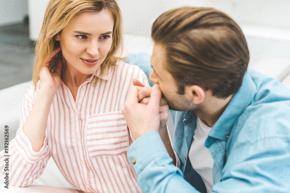 portrait of tender man kissing wifes hand at home portrait of tender man kissing wifes hand at home