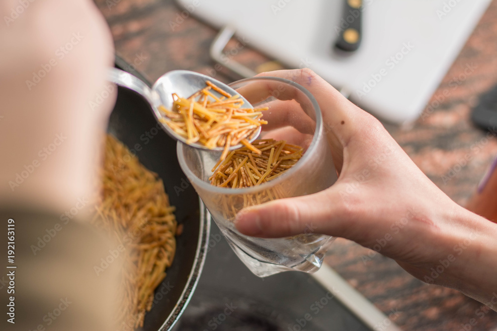 cooking a spanish fideua, a typical noodles casserole with seafood