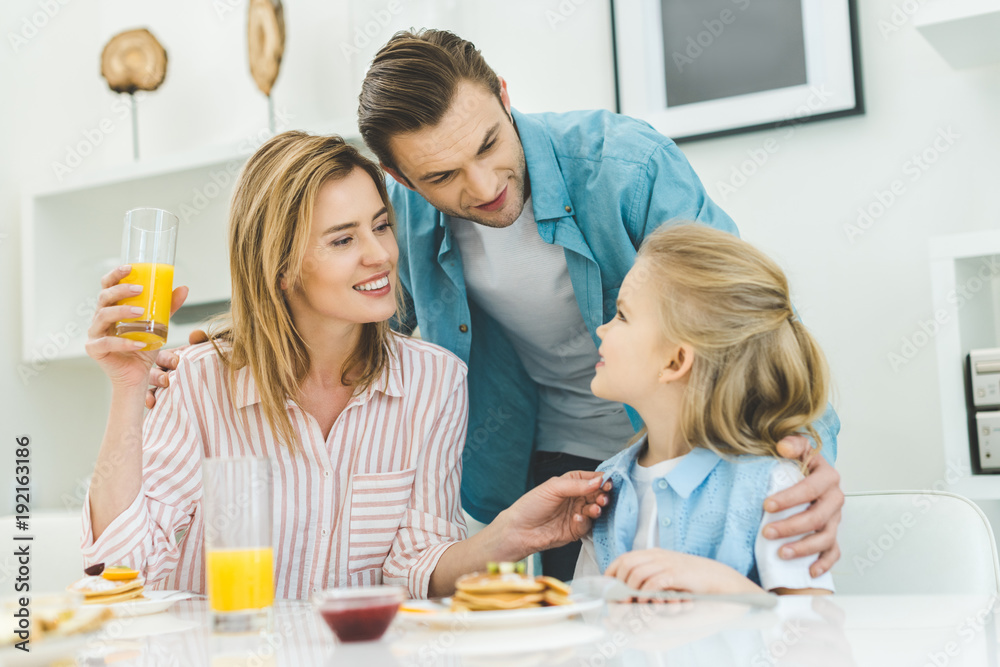 happy family having breakfast together at home happy family having breakfast together at home