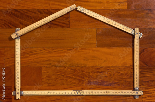 House Shaped Folded Measuring Stick on Wooden Background