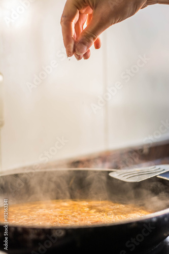 cooking a spanish fideua, a typical noodles casserole with seafood, making traditional Fideua from Spain, a typical noodle paella