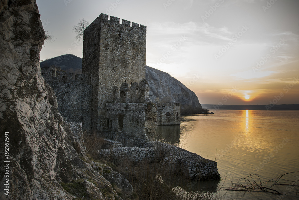 Stronghold on the Danube/travel picture of a fourteen century stronghold ruin on the river Danube in Serbia at sunset.