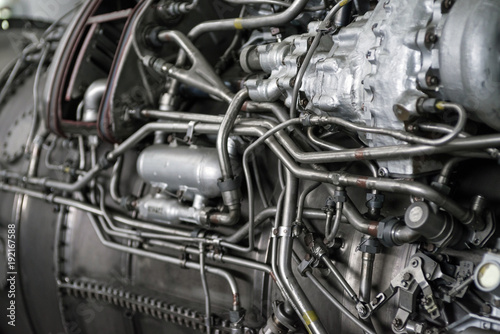 Fragment of a complex mechanical aggregate with various communication and control organs. Engine fragment of a military aircraft. Selective focus.