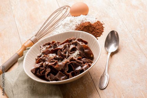 homemade cocoa tagliatelle with butter and parmesan cheese