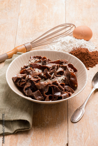 homemade cocoa tagliatelle with butter and parmesan cheese