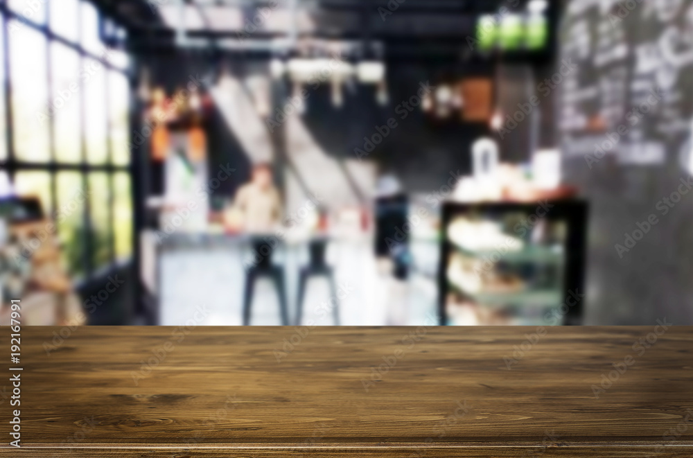 Selected focus empty brown wooden table and Coffee shop or restaurant blur background with bokeh image. for your photomontage or product display. Selected focus empty brown wooden table and Coffee shop or restaurant blur background with bokeh image. for your photomontage or product display.