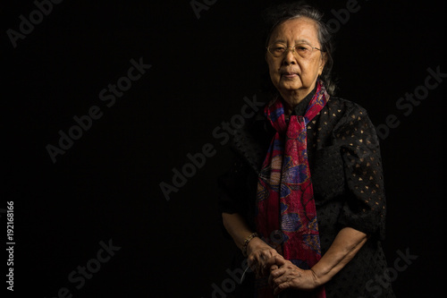Asian senior woman holding walking stick