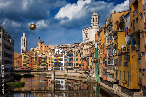 Colorful yellow and orange houses and bridge Pont de Sant Agusti reflected in water river Onyar  in Girona  Catalonia  Spain