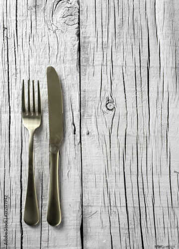 fork and knife on a white rustic wooden table