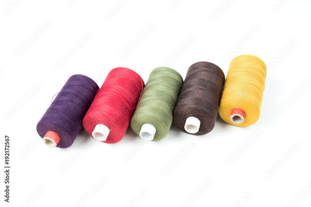 Coloured thread coils on white background, sewing Coloured thread coils on white background, sewing