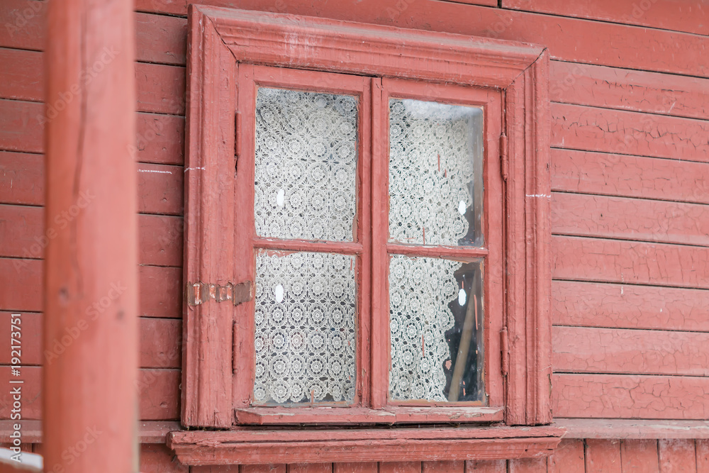 small window in  wall of old wooden house