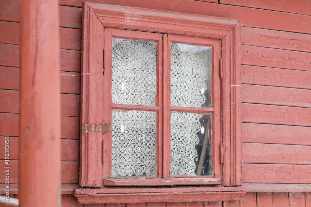 small window in wall of old wooden house small window in wall of old wooden house