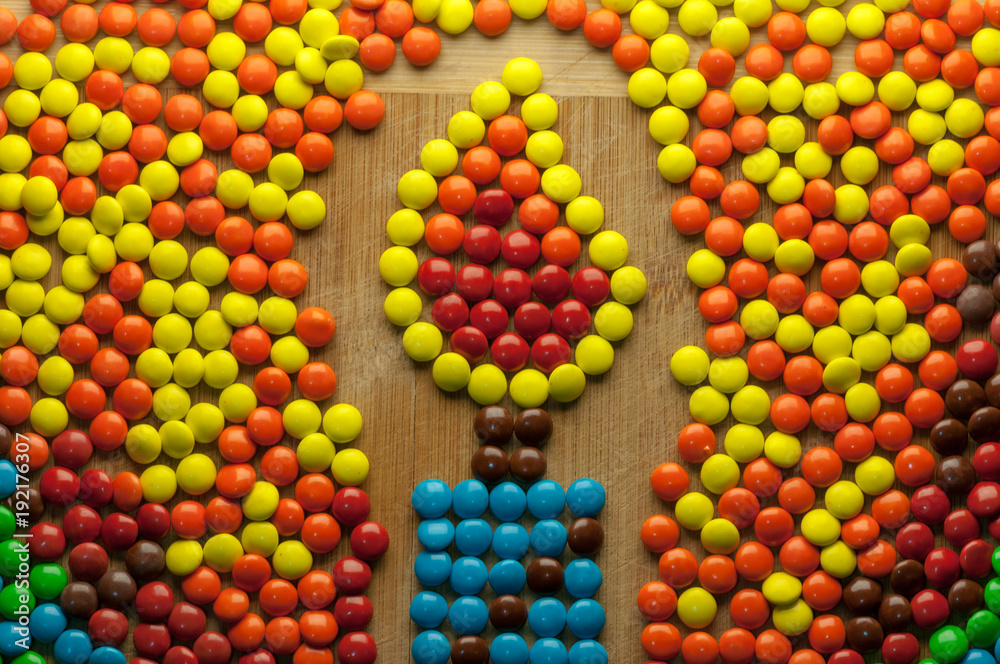 Hanukkah candle symbol made out of colorful round chocolate candy Hanukkah candle symbol made out of colorful round chocolate candy