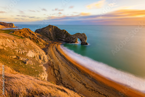 Bild auf Leinwand Gorgeous golden light at the famous Durdle Door on the Jurassic Coast, Dorset, UK