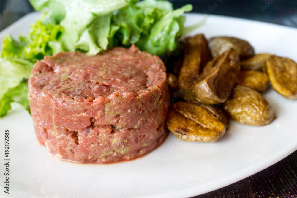 tasty Steak tartare (Raw beef) - classic steak tartare on white plate