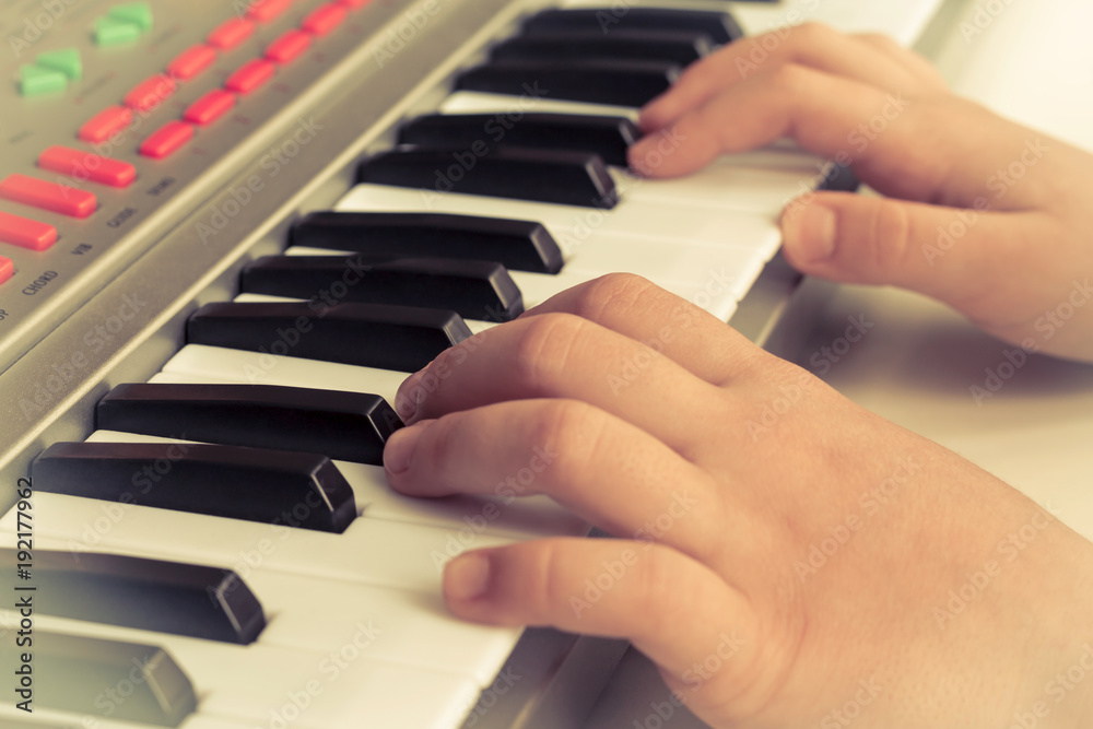 child plays on piano, synthesizer. Concept Training, Education, School